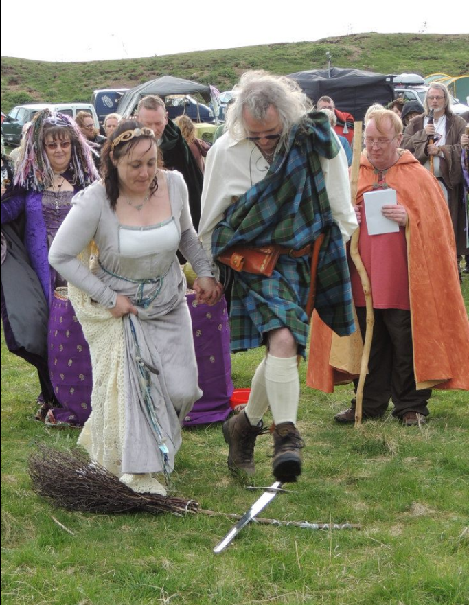 Mr & Mrs Mead jump the broom and crossed sword in 2013